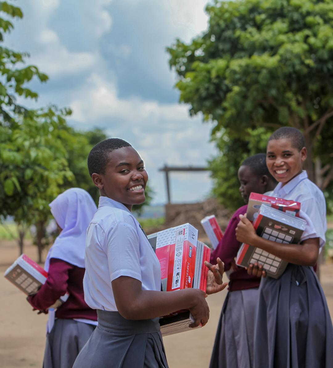Two volunteers in green recycling t-shirts promoting education